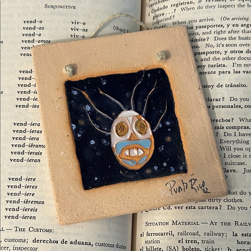 Puerto Rico ceramic tile art with a Vejigante face signed by artist